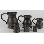 Pewter measuring jugs. A set of six graduated pewter measuring jugs, height 16cm & smaller
