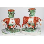 Two Staffordshire cow and calf spill vases, both with some damage, height 28cm approx. (sold as