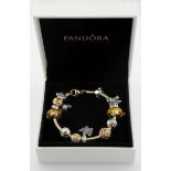 Gold Bracelet, tests as 14ct, with Gold and Silver Pandora charms, in a Pandora box.