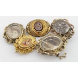 Five 9ct / Yellow metal mourning brooches with four having locks of hair encased.