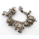 Silver charm bracelet with a selection of charms attached, total weight 79.7g