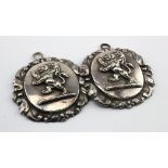 Two old silver fronted horse fittings each depicting a two headed lion, 75mm in width.