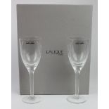 Lalique. Pair of Lalique crystal wine glasses, with white opalescent cherub decoration, height 20.