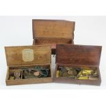 Two cased sets of coin scales plus one empty coin scales box.