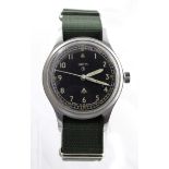 Military issue stainless steel gents wristwatch by Smiths. The black dial with Arabic numerals and