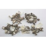 Five silver & white metal charm bracelets, total weight 310g approx.
