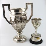 Two Tutton Trophies, the larger of the two has Chinese silver marks on the base and it weighs