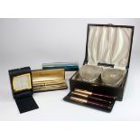 Pens. A three piece Parker 65 pen & pencil set (maroon with gold coloured lids), with three other