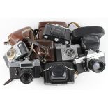 Cameras. Ten vintage cameras, including Rolleiflex SL35, Zenit E, Zeiss Ikon Nettar, Braun