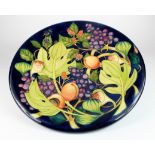 Moorcroft large charger / plate, circa 2000, decorated with grapes and berries, impressed &