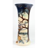 Moorcroft. A tall Moorcroft vase, circa 1999, depicting a snowy countryside scene with two foxes,