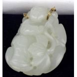 Jade. A carved jade pendant, depicting a buddha, 50mm x 32mm approx.