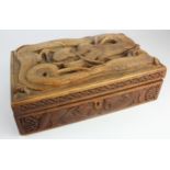 Carved wooden box, depicting a Chinese dragon to lid, one hinge missing, height 10cm, width 30.5cm