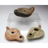 Three Roman Terracotta Oil Lamps. C, 2nd to 6th century AD. Various styles and patterns. Two intact,