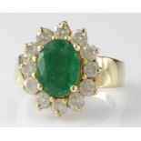 Tested as 18ct yellow gold emerald and diamond oval cluster ring, finger size L, weight 9.6g