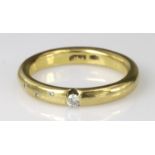 18ct gold band ring set with varying size diamonds, finger size O, weight 5.9g