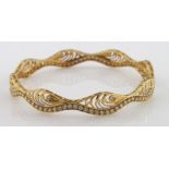 High carat (tests as approx 20ct) yellow gold wavy slave bangle set with cubic zirconia, 15.2g