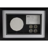 Plaster cast of the new One Pound coin, mounted in a frame along with two examples each of the