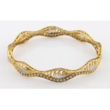 High carat (tests as approx 20ct) yellow gold slave bangle set with cubic zirconia, weight 15.2g