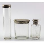 Three silver mounted glass toilet jars with silver tops hallmarked for London 1925. Weight of free