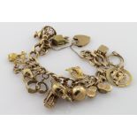 9ct charm bracelet with a good variety of charms attached, total weight 60.2g