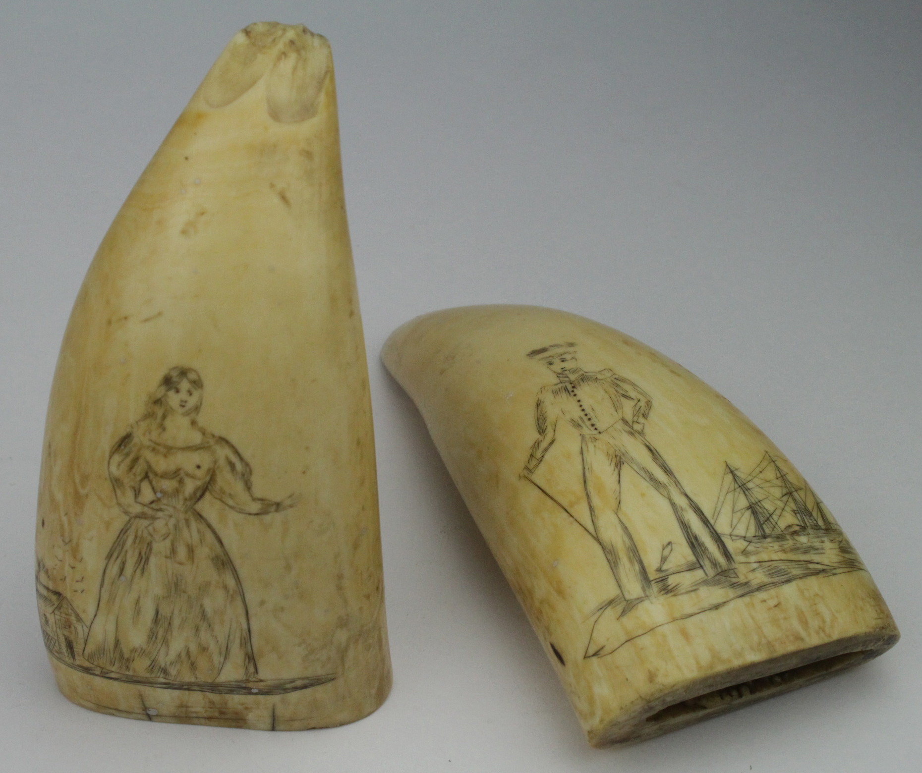 Scrimshaw. Two 19th Century carved whales teeth, depicting a sailor with tall ship in background,