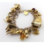 9ct charm bracelet with a good variety of charms attached, total weight 51.3g