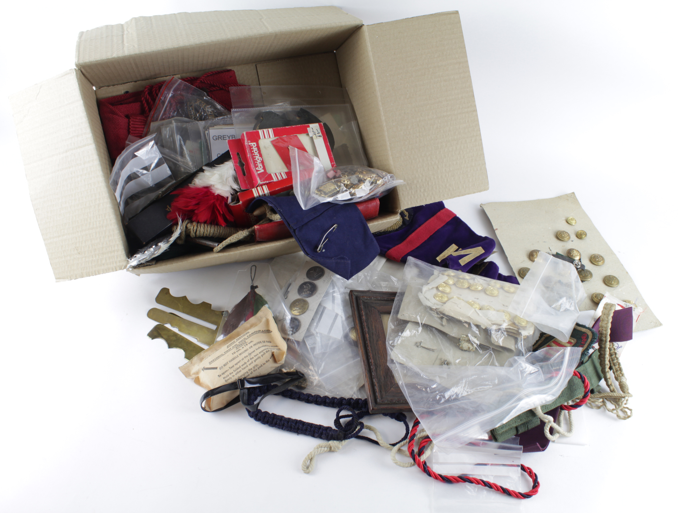 Assorted Militaria in a box - Badges, Buttons, Hackles, Lanyards, Ephemera, Pennant, Bayonet Frog.