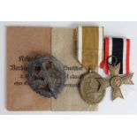 German War Merit Cross in packet, a West Wall medal & packet plus an early variant SA Sports badge.