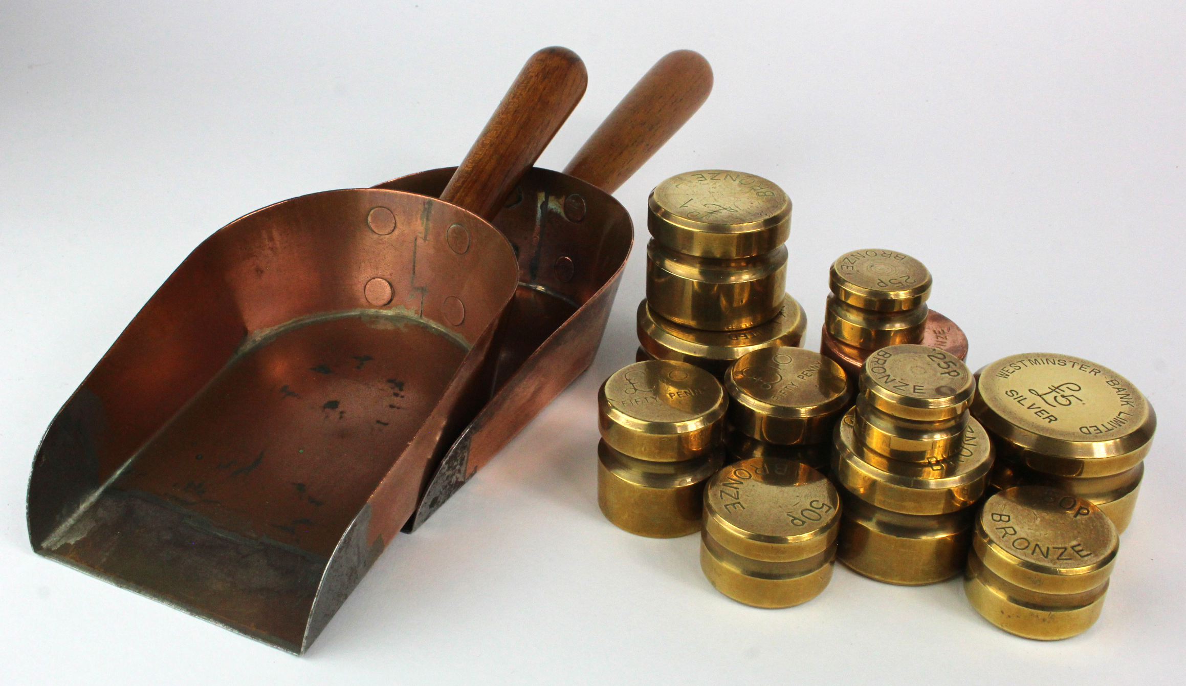 Banking Memorabilia: A quantity of large coin weights and coin shovels.