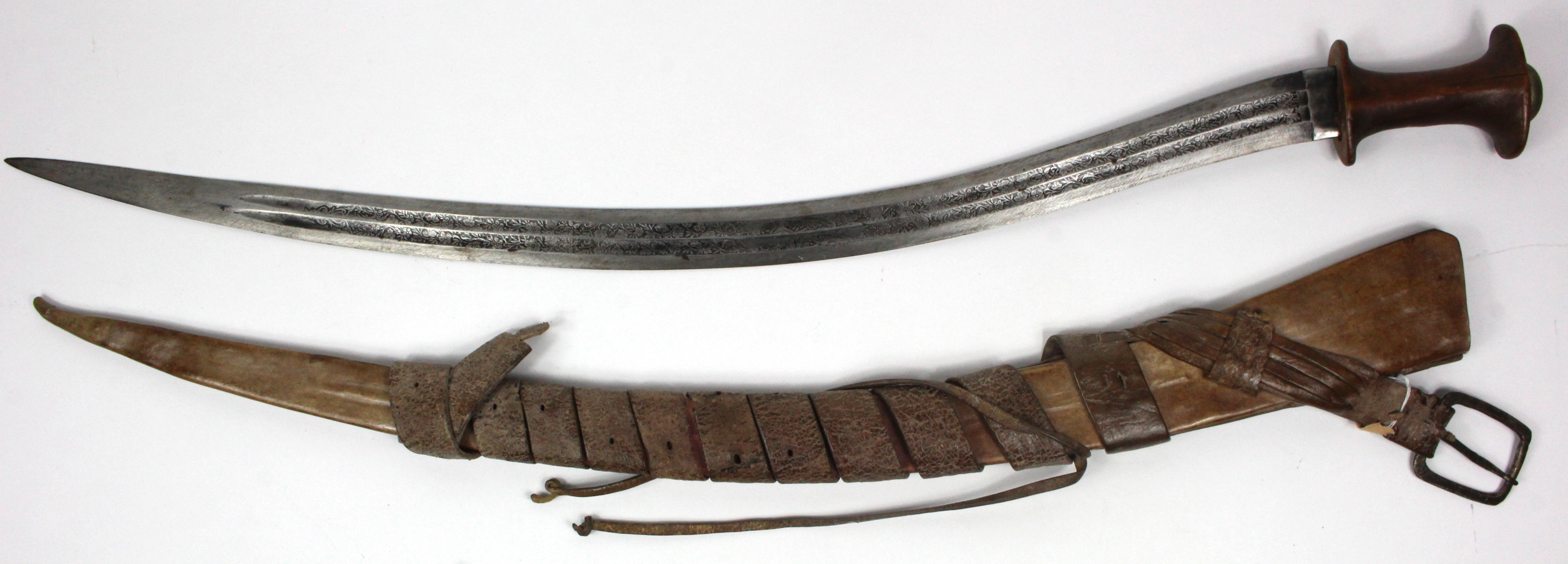 Ethiopian early shotel sword with original leather scabbard and buckle. Blade highly decorated.