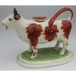 Staffordshire cow creamer jug, circa 19th century, height 12cm, length 14cm approx.
