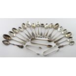 Twenty-one items of mixed silver flatware (spoons and tongs). Nineteen bear British hallmarks (