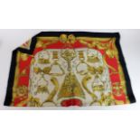 Hermes. An original Hermes silk scarf ''Etriers Hermes Paris', in cream, red, black & gold, 90cm x