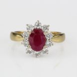 18ct yellow gold ring set with an oval ruby surrounded by ten round brilliant cut diamonds approx.