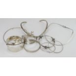 Silver. A group of nine silver & white metal bangles & bracelets, weight 6.1 oz. approx.