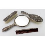 Four piece silver backed dressing table se, comprising two brushes, a hand mirror and a comb,