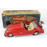 Distler clockwork tinplate Mercedes Benz open top sports car, red with cream interior, key