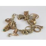 9ct Charm bracelet with a good assortment of charms attached. total weight 39.8g