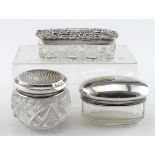 Three silver topped small glass jars/tidies of various sizes. Weight of silver 1.75oz approx.