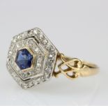 18ct yellow gold ring set with central hexagonal sapphire surrounded by two rows of mine cut