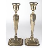 Composite pair of silver candlesticks (different sizes 25.25cm and 26cm approx.) Both have loaded