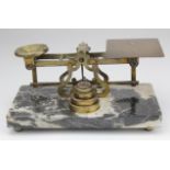 Brass set of postal scales by Sampson Mordan & Co., on a marble base raised on four brass ball feet,