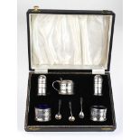 Boxed five piece silver cruet set, three silver spoons and five blue glass liners. Five pieces
