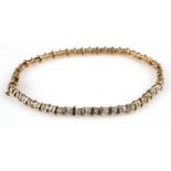 9ct yellow gold tennis bracelet set with a diamond in alternating links totalling 0.23ct, weight 4.