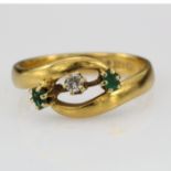 22ct ring set with a centre diamond flanked by two emeralds, Size Q 5.3g