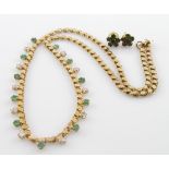 Ladies yellow metal necklace (stamped 14k) with green and white stones, total length approx 24cm