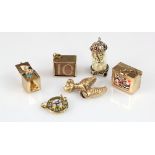 Six 9ct yellow gold charms to include a poodle, clock, pack of cards, telephone dial, jack in a