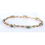 Yellow metal bracelet (tests as 14ct) with green and white stones, approx 7.5 inches in length,