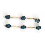 Yellow metal (tests as 9ct) drop earrings each set with three semi-precious blue stones & small